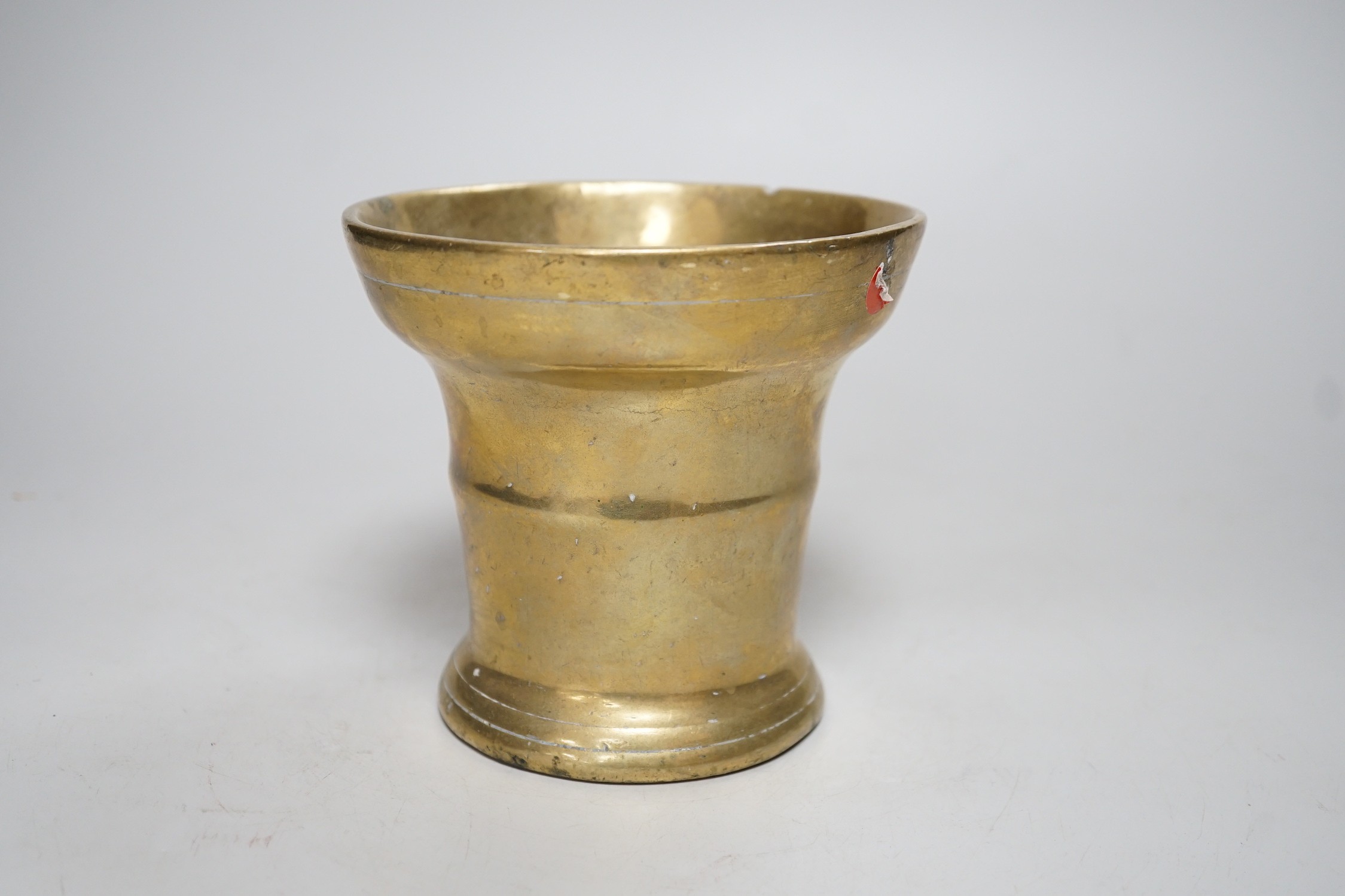 A 17th century bronze mortar. 12cm tall